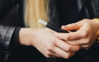 Girl holding ecigarette in case