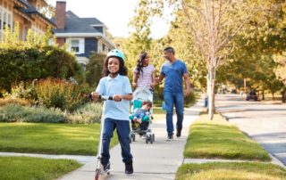 Family on neighborhood sidewalk