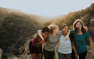Friends outside hiking and smiling