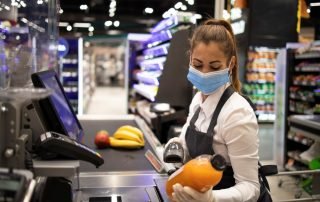 Grocery store checkout cashier with mask