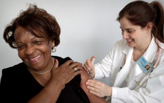Woman receiving injection in arm